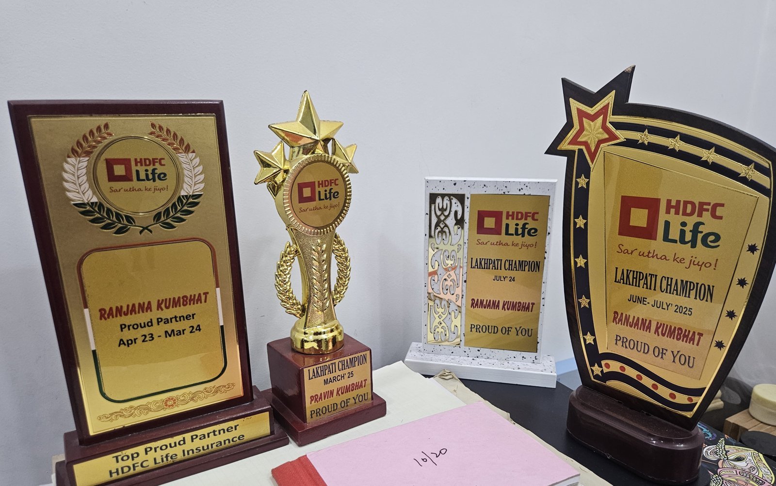 HDFC Life awards earned by the Pravinjana Consultants team, including the Top Proud Partner and Lakhpati Champion recognitions